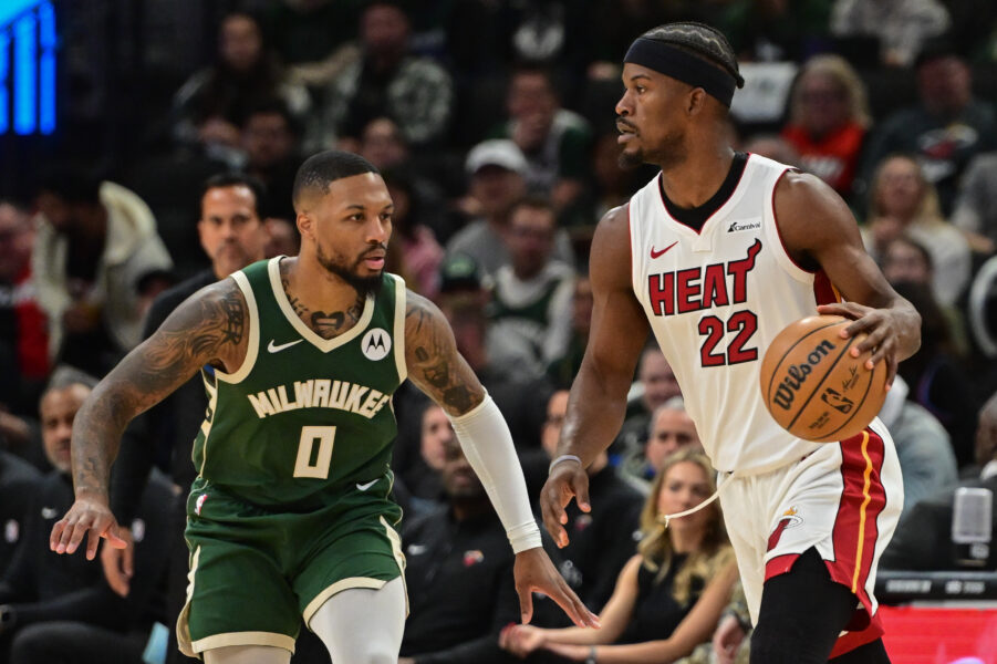 Oct 30, 2023; Milwaukee, Wisconsin, USA; Miami Heat center Jimmy Butler (22) is defended by Milwaukee Bucks guard Damian Lillard (0) in the first quarter at Fiserv Forum. Mandatory Credit: Benny Sieu-Imagn Images