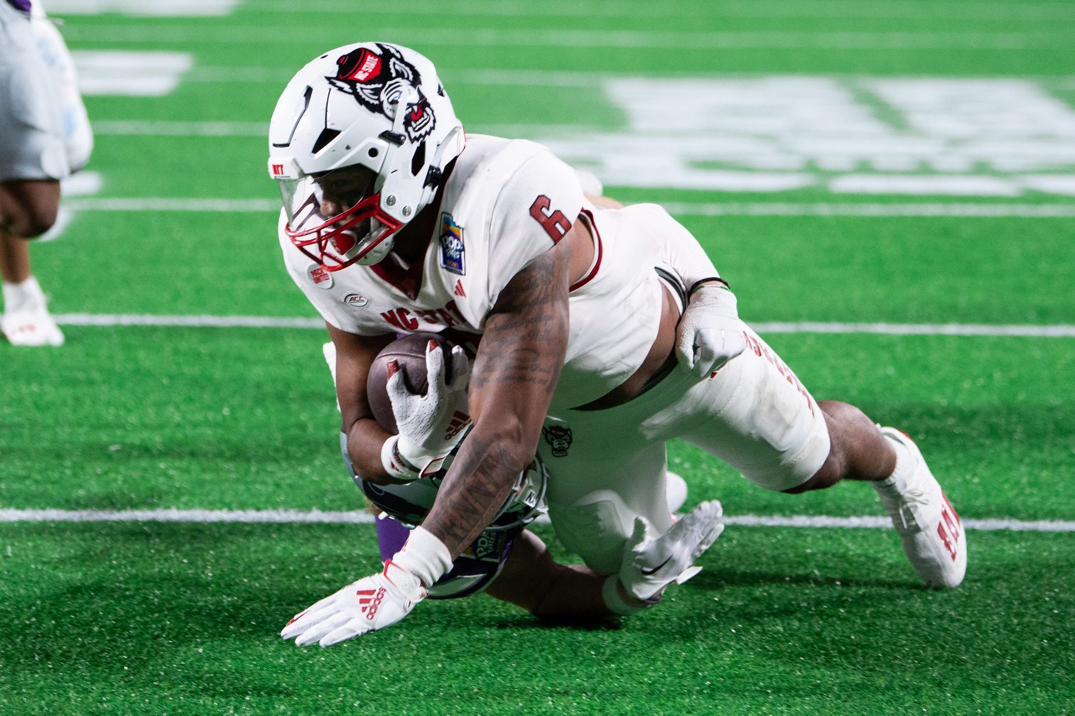 Dec 28, 2023; Orlando, FL, USA; NC State tight end Trent Pennix (6) leaps for the touchdown against Kansas State in the third quarter at Camping World Stadium. Mandatory Credit: Jeremy Reper-Imagn Images Packers