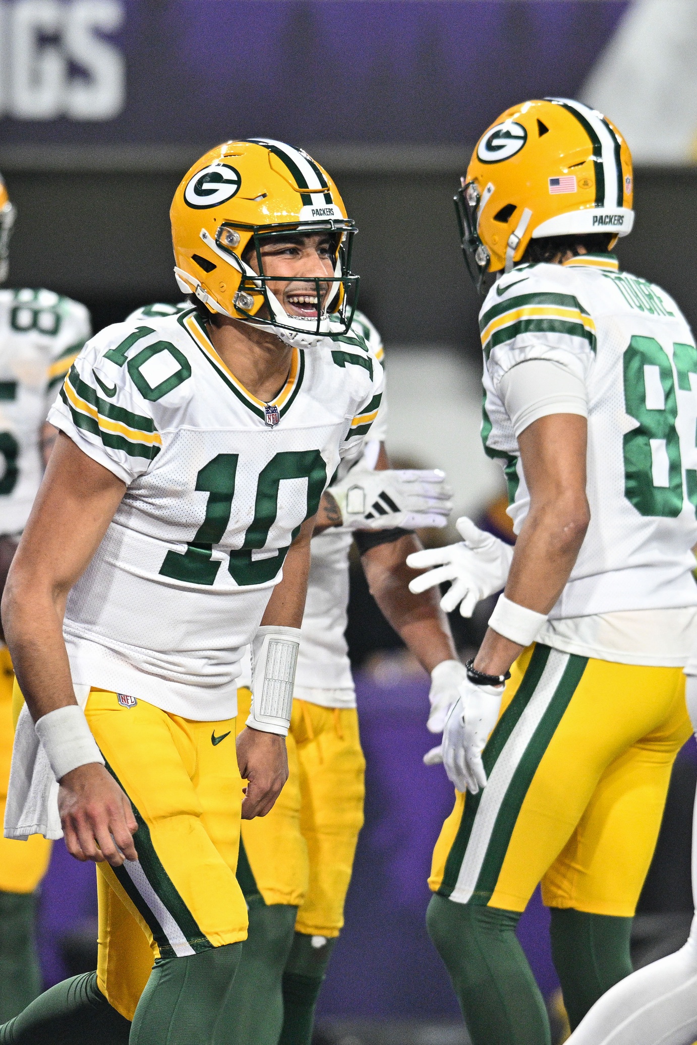 Dec 31, 2023; Minneapolis, Minnesota, USA; Green Bay Packers quarterback Jordan Love (10) reacts with wide receiver Samori Toure (83) against the Minnesota Vikings during the game at U.S. Bank Stadium. Mandatory Credit: Jeffrey Becker-USA TODAY Sports