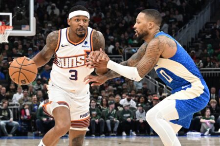 Mar 17, 2024; Milwaukee, Wisconsin, USA; Phoenix Suns guard Bradley Beal (3) drives against Milwaukee Bucks guard Damian Lillard (0) on the second half at Fiserv Forum. Mandatory Credit: Michael McLoone-Imagn Images