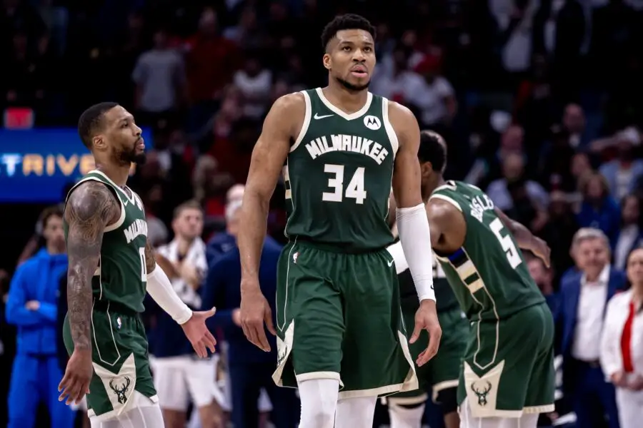 Milwaukee Bucks forward Giannis Antetokounmpo (34) and guard Damian Lillard (0) head to the bench on a timer out against the New Orleans Pelicans