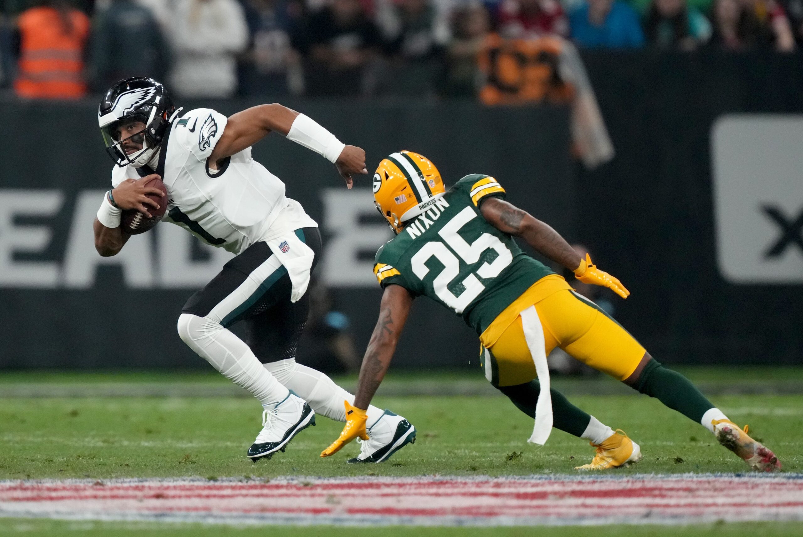 Sep 6, 2024; Sao Paulo, BRA; Philadelphia Eagles quarterback Jalen Hurts (1) runs against Green Bay Packers cornerback Keisean Nixon (25) during the first quarter at Neo Quimica Arena. Mandatory Credit: Kirby Lee-Imagn Images