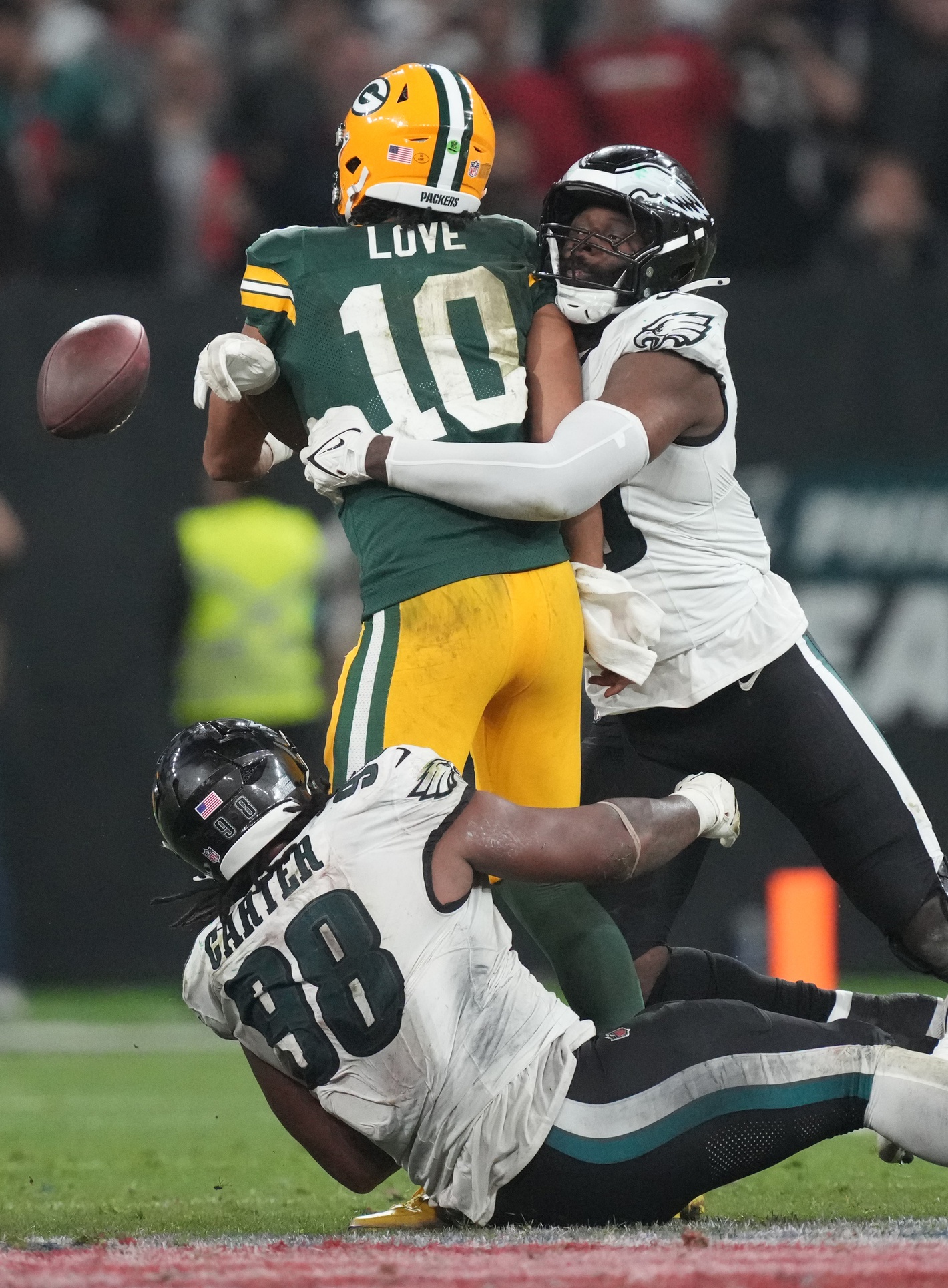 Sep 6, 2024; Sao Paulo, BRA; Green Bay Packers quarterback Jordan Love (10) is pressured by Philadelphia Eagles defensive tackle Jalen Carter (98) and linebacker Josh Sweat (19) during the second half at Neo Quimica Arena. Mandatory Credit: Kirby Lee-Imagn Images