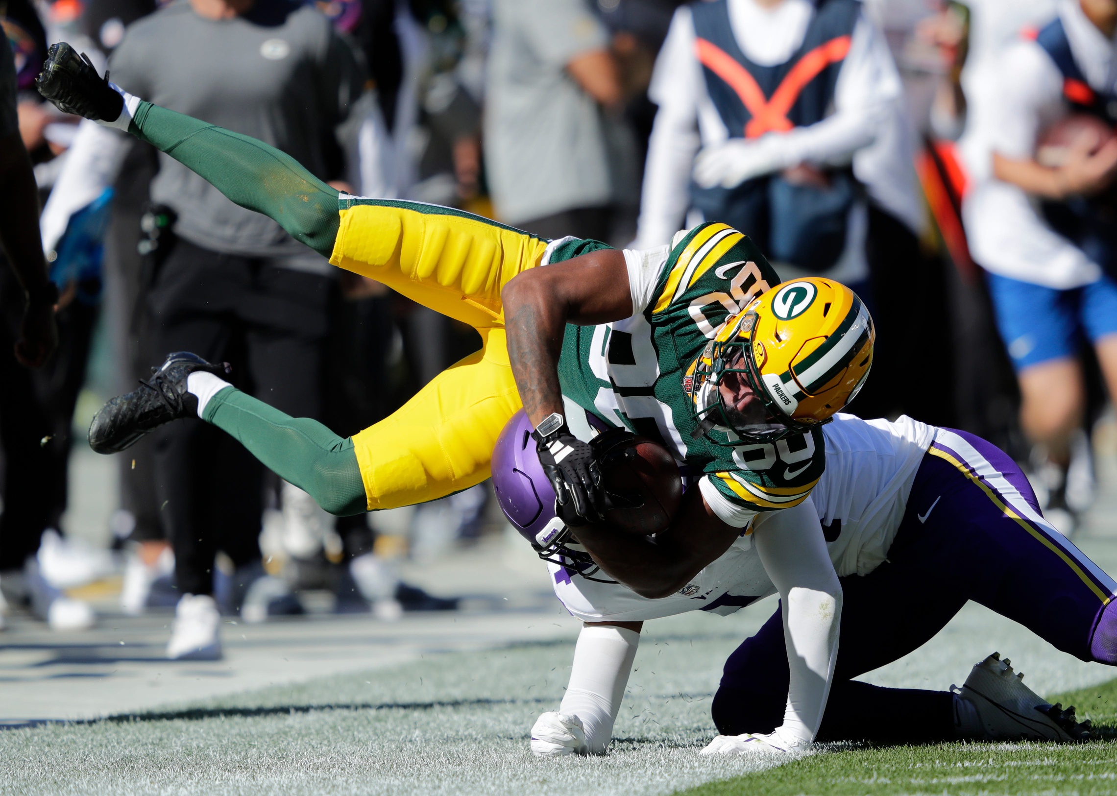 Green Bay Packers wide receiver Bo Melton (80) is knocked out of bounds on a pass reception against Minnesota Vikings safety Camryn Bynum (24) during their football game Sunday, September 29, 2024, at Lambeau Field in Green Bay, Wisconsin. D. © Dan Powers/USA TODAY NETWORK-Wisconsin / USA TODAY NETWORK via Imagn Images