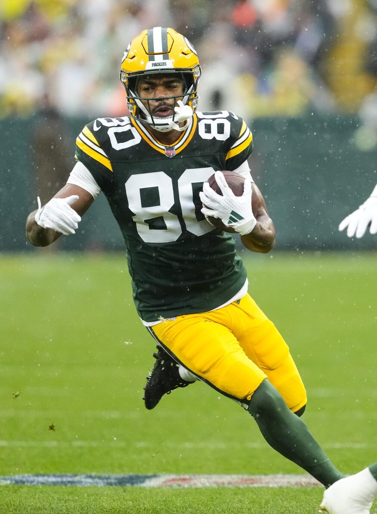 Oct 13, 2024; Green Bay, Wisconsin, USA; Green Bay Packers wide receiver Bo Melton (80) rushes with the football during the first quarter against the Arizona Cardinals at Lambeau Field. Mandatory Credit: Jeff Hanisch-Imagn Images