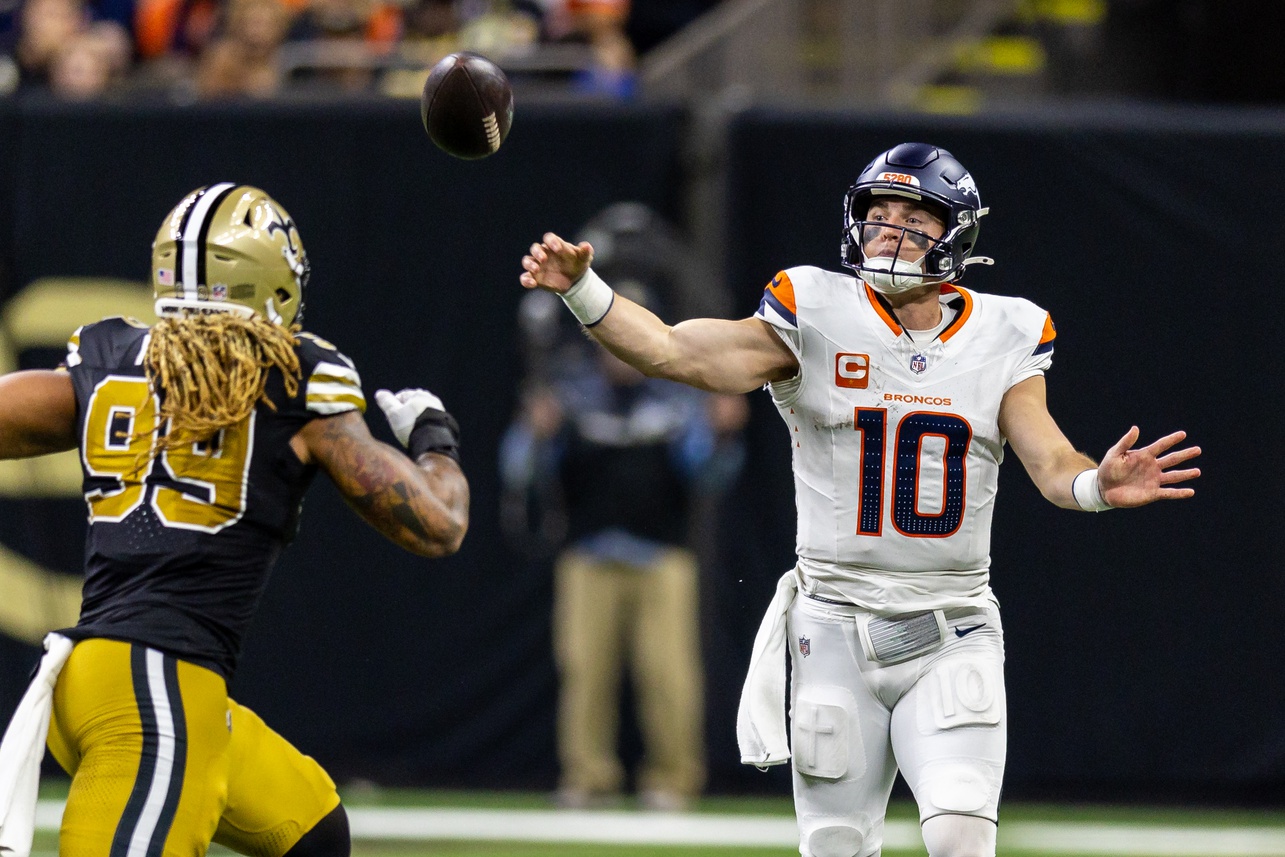 Oct 17, 2024; New Orleans, Louisiana, USA; Denver Broncos quarterback Bo Nix (10) passes over New Orleans Saints defensive end Chase Young (99) during the first half at Caesars Superdome. Mandatory Credit: Stephen Lew-Imagn Images Packers