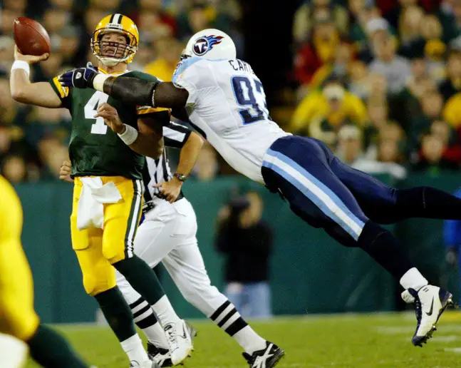 Tennessee Titans defensive lineman Kevin Carter, right, pressures Green Bay Packers quarterback Brett Favre during action at Lambeau Field in Green Bay, Wis., on Oct. 11, 2004. The Titans won the Monday Night game 48-27. © Sanford Myers / The Tennessean / USA TODAY NETWORK via Imagn Images