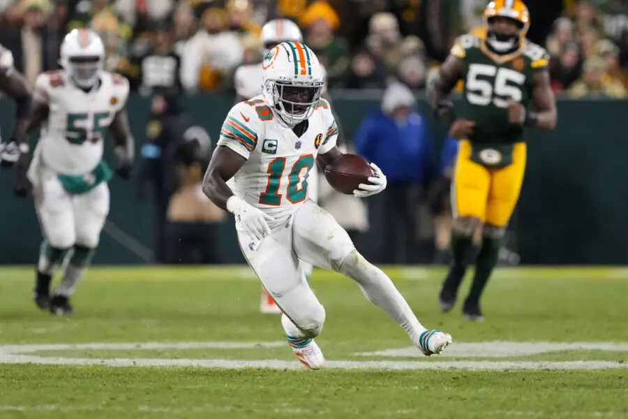 Nov 28, 2024; Green Bay, Wisconsin, USA; Miami Dolphins wide receiver Tyreek Hill (10) rushes with the football during the fourth quarter against the Green Bay Packers at Lambeau Field. Mandatory Credit: Jeff Hanisch-Imagn Images