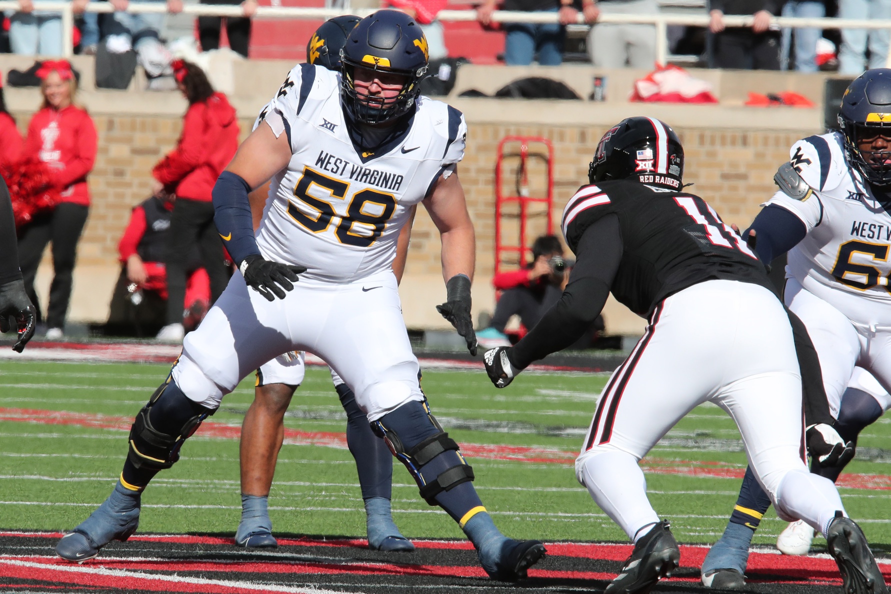 Nov 30, 2024; Lubbock, Texas, USA; West Virginia Mountaineers offensive tackle Nick Malone (58) blocks Texas Tech Red Raiders defensive back Charles Esters III (11) in the second half at Jones AT&T Stadium and Cody Campbell Field. Mandatory Credit: Michael C. Johnson-Imagn Images