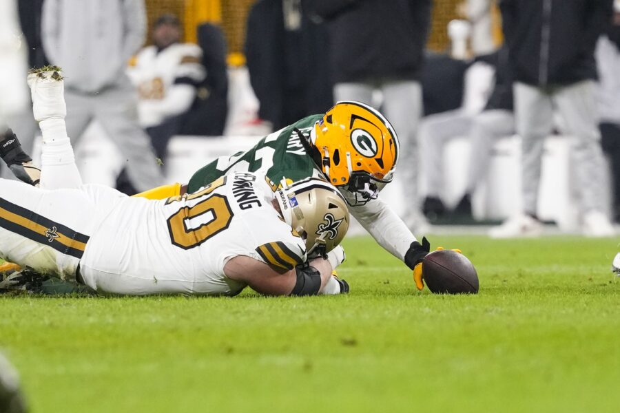 Dec 23, 2024; Green Bay, Wisconsin, USA; Green Bay Packers defensive end Rashan Gary (52) recovers a fumble against New Orleans Saints offensive tackle Trevor Penning (70) during the second quarter at Lambeau Field. Mandatory Credit: Jeff Hanisch-Imagn Images