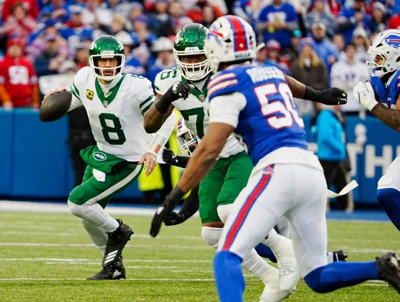 Green Bay Packers Aaron Rodgers New York Jets quarterback Aaron Rodgers (8) scrambles looking for an open receiver while keeping an eye on Buffalo Bills defensive end Greg Rousseau (50) who was heading towards him during first half action at the Bills home game against the New York Jets at Highmark Stadium in Orchard Park on Dec. 29, 2024.