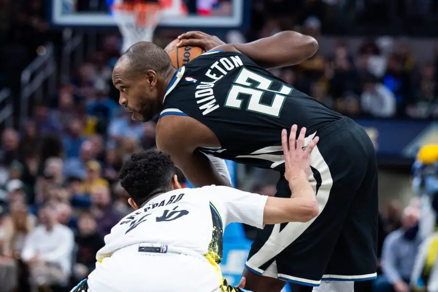 Dec 31, 2024; Indianapolis, Indiana, USA; Milwaukee Bucks forward Khris Middleton (22) holds the ball while Indiana Pacers guard Ben Sheppard (26) defends in the second half at Gainbridge Fieldhouse. Mandatory Credit: Trevor Ruszkowski-Imagn Images