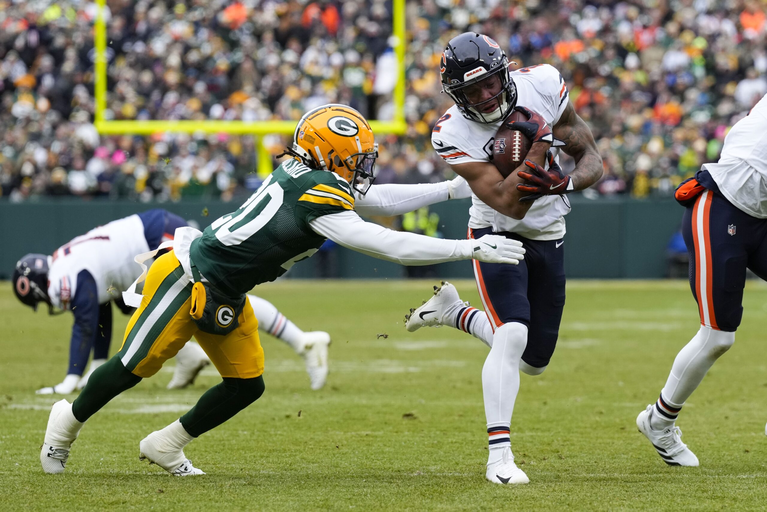 Jan 5, 2025; Green Bay, Wisconsin, USA; Chicago Bears wide receiver DJ Moore (2) rushes with the football as Green Bay Packers safety Javon Bullard (20) defends during the second quarter at Lambeau Field. Mandatory Credit: Jeff Hanisch-Imagn Images