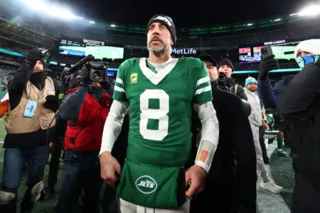 Jan 5, 2025; East Rutherford, New Jersey, USA; New York Jets quarterback Aaron Rodgers (8) walks on the field after the Jets win over the Miami Dolphins at MetLife Stadium. Mandatory Credit: Ed Mulholland-Imagn Images