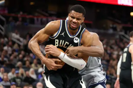 Jan 10, 2025; Orlando, Florida, USA; Milwaukee Bucks forward Giannis Antetokounmpo (34) and Orlando Magic center Wendell Carter Jr. (34) fight for a loose ball in the fourth quarter at Kia Center. Mandatory Credit: Nathan Ray Seebeck-Imagn Images