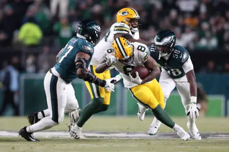 Jan 12, 2025; Philadelphia, Pennsylvania, USA; Green Bay Packers running back Josh Jacobs (8) rushes the ball against the Philadelphia Eagles during the first half in an NFC wild card game at Lincoln Financial Field. Mandatory Credit: Bill Streicher-Imagn Images