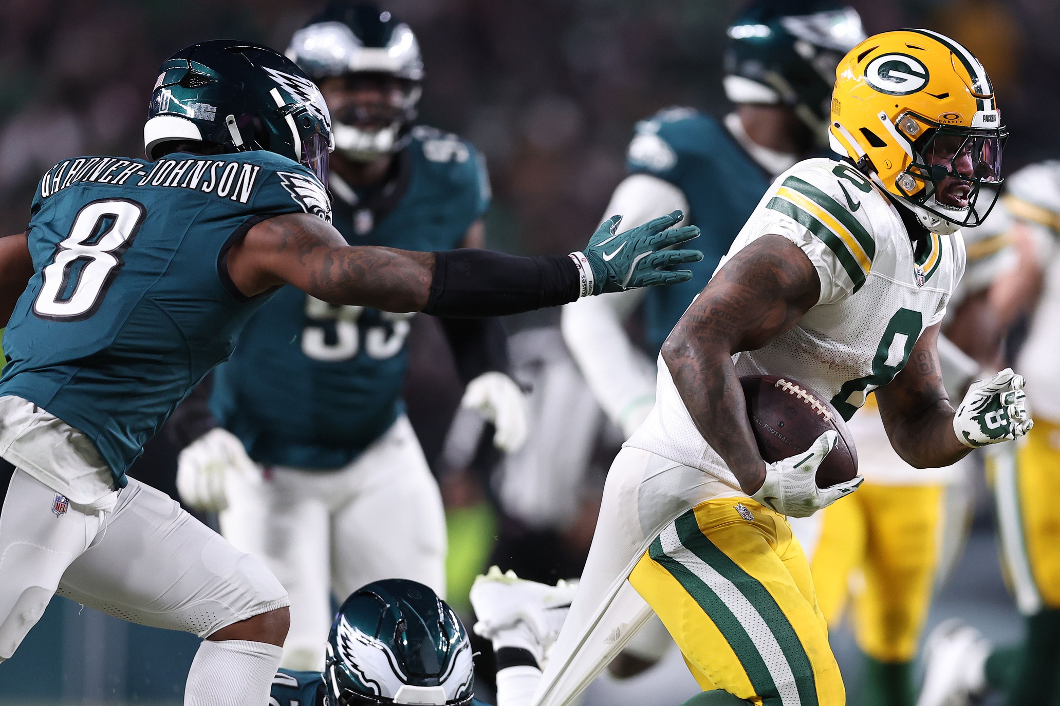 Jan 12, 2025; Philadelphia, Pennsylvania, USA; Green Bay Packers running back Josh Jacobs (8) rushes the ball agaistn Philadelphia Eagles linebacker Oren Burks (42) in an NFC wild card game at Lincoln Financial Field. Mandatory Credit: Bill Streicher-Imagn Images