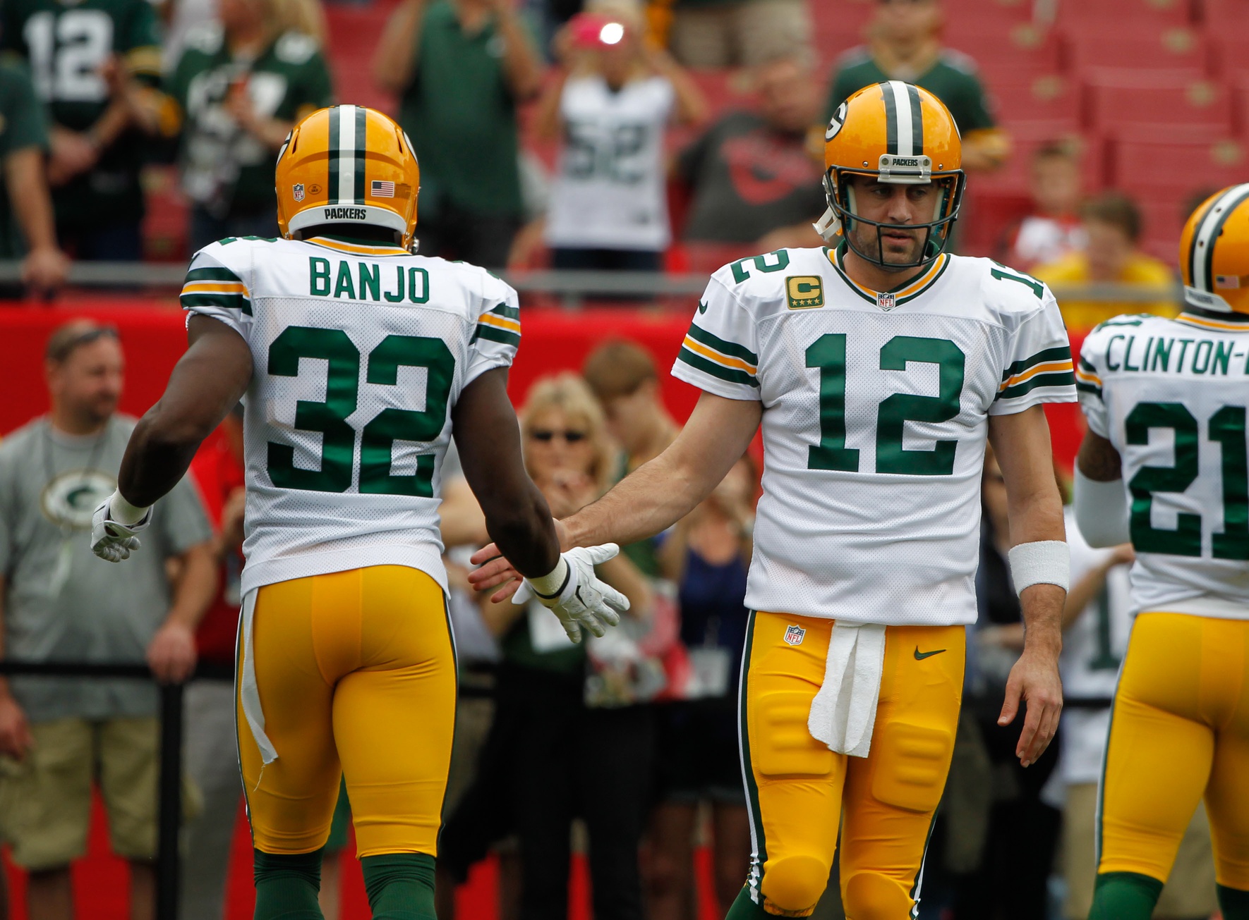 Dec 21, 2014; Tampa, FL, USA; Green Bay Packers quarterback Aaron Rodgers (12) and strong safety Chris Banjo (32) work out prior to the game against the Tampa Bay Buccaneers at Raymond James Stadium. Mandatory Credit: Kim Klement-Imagn Images