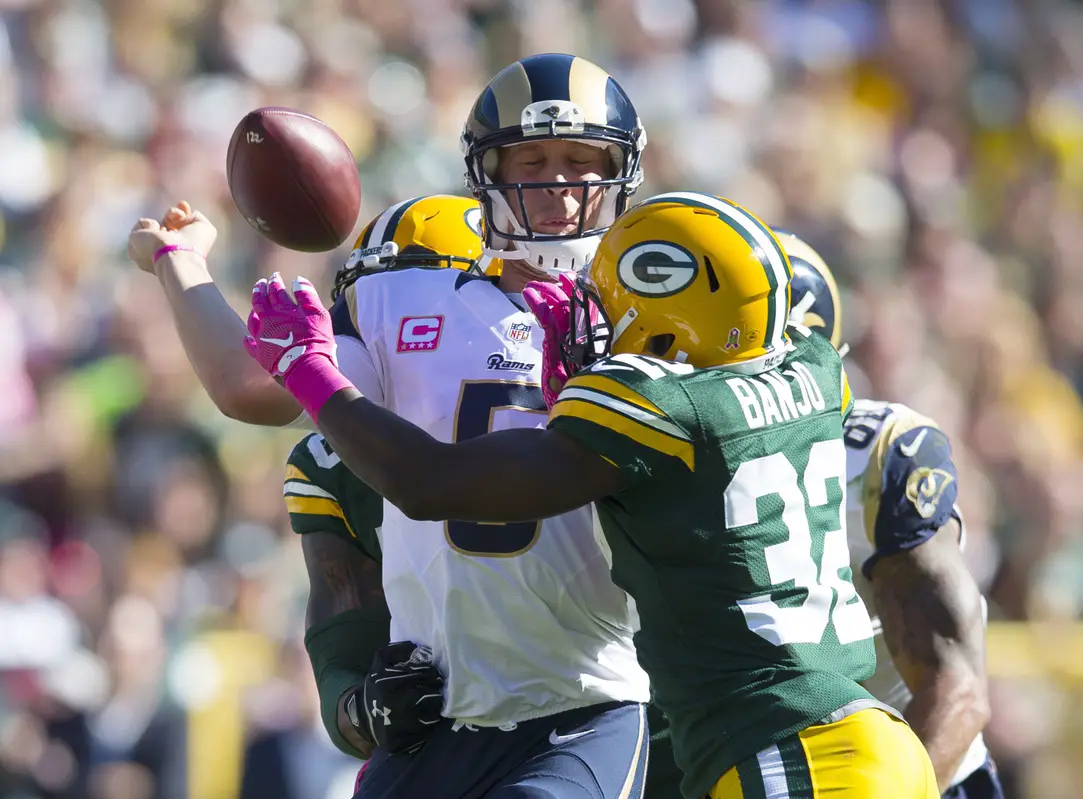 Oct 11, 2015; Green Bay, WI, USA; St. Louis Rams quarterback Nick Foles (5) has the football knocked away under pressure from Green Bay Packers safety Chris Banjo (32) during the third quarter at Lambeau Field. Green Bay won 24-10. Mandatory Credit: Jeff Hanisch-Imagn Images