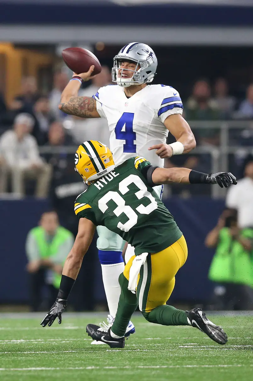 Jan 15, 2017; Arlington, TX, USA; Dallas Cowboys quarterback Dak Prescott (4) throws under pressure from Green Bay Packers safety Micah Hyde (33) in the NFC Divisional playoff game at AT&T Stadium. Mandatory Credit: Matthew Emmons