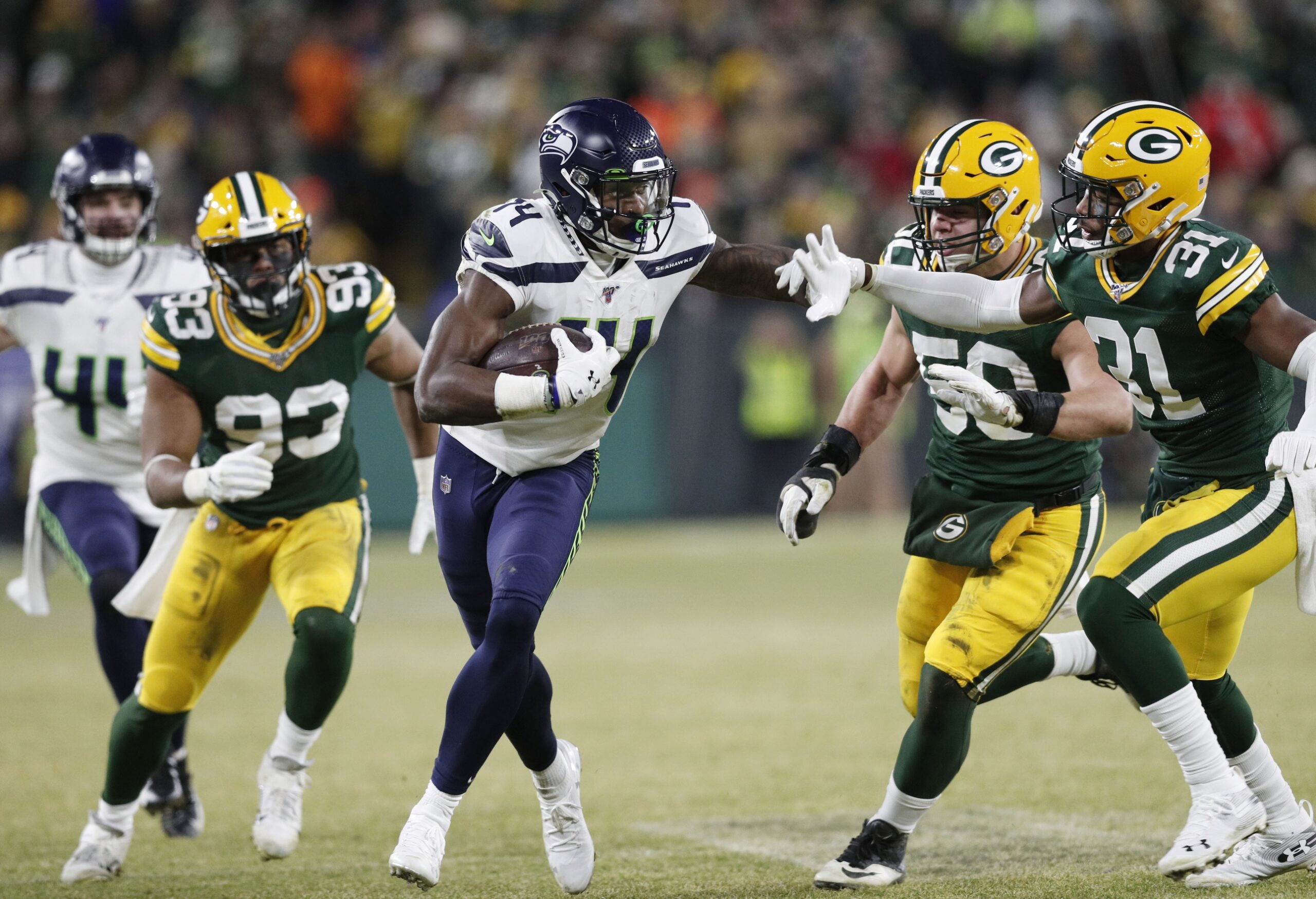 Jan 12, 2020; Green Bay, WI, USA; Seattle Seahawks wide receiver D.K. Metcalf (14) tries to get away from Green Bay Packers strong safety Adrian Amos (31) in the third quarter of a NFC Divisional Round playoff football game at Lambeau Field. Mandatory Credit: Jeff Hanisch-Imagn Images