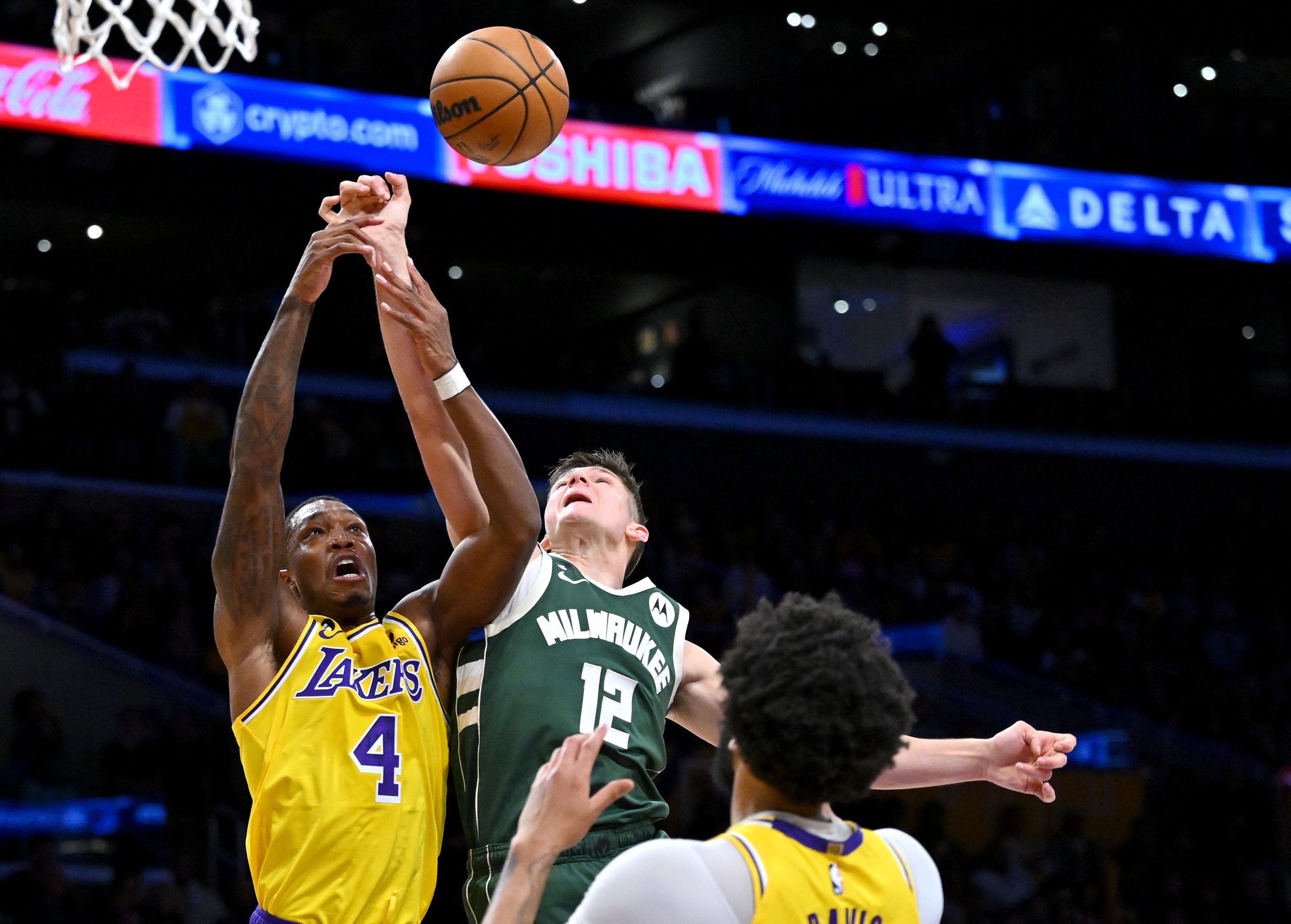 Feb 9, 2023; Los Angeles, California, USA; Los Angeles Lakers guard Lonnie Walker IV (4) and Milwaukee Bucks guard Grayson Allen (12) reach for a rebound in the first half at Crypto.com Arena. Mandatory Credit: Jayne Kamin-Oncea-Imagn Images