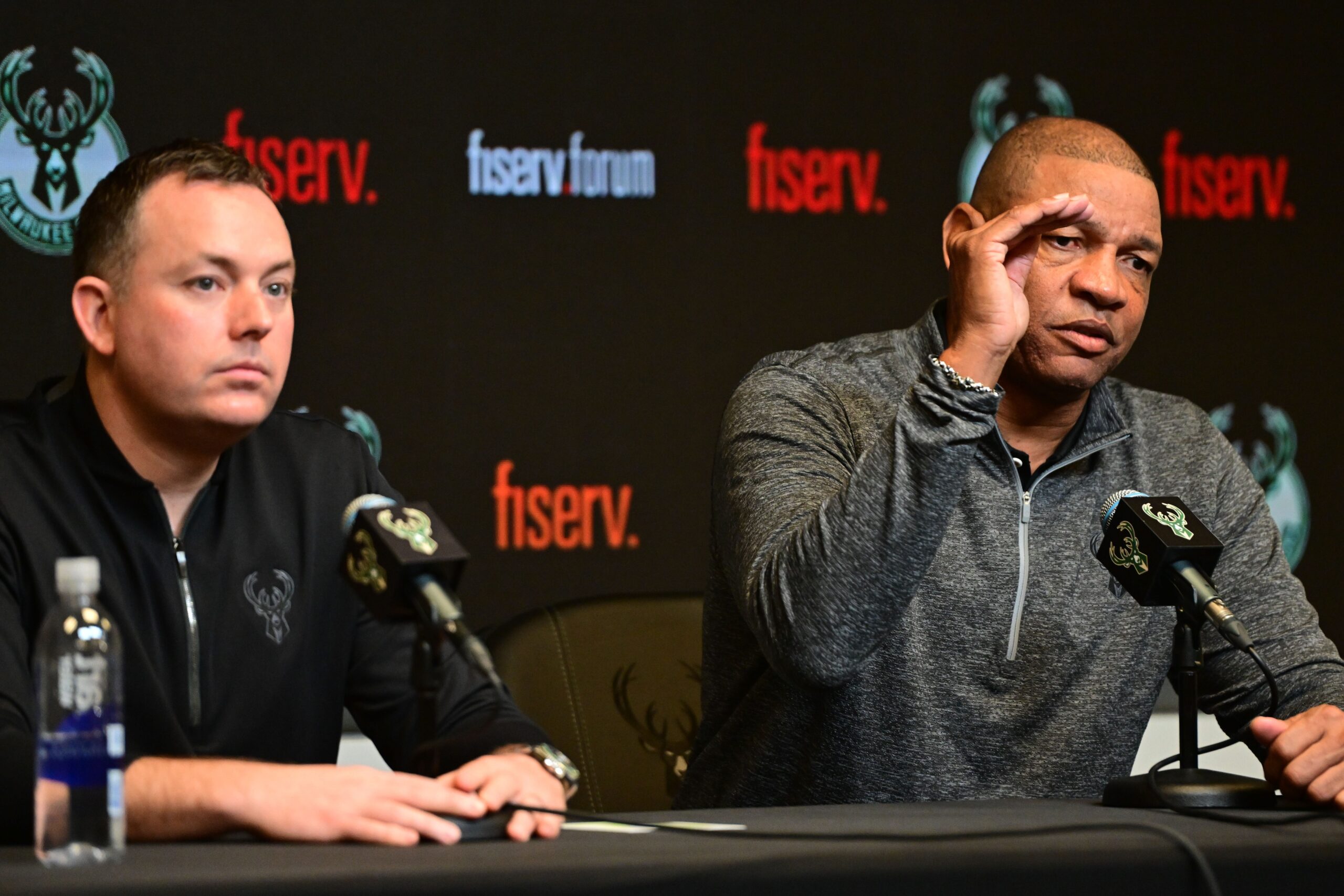 Doc Rivers (right) speaks at a press conference with general manager Jon Horst as Rivers