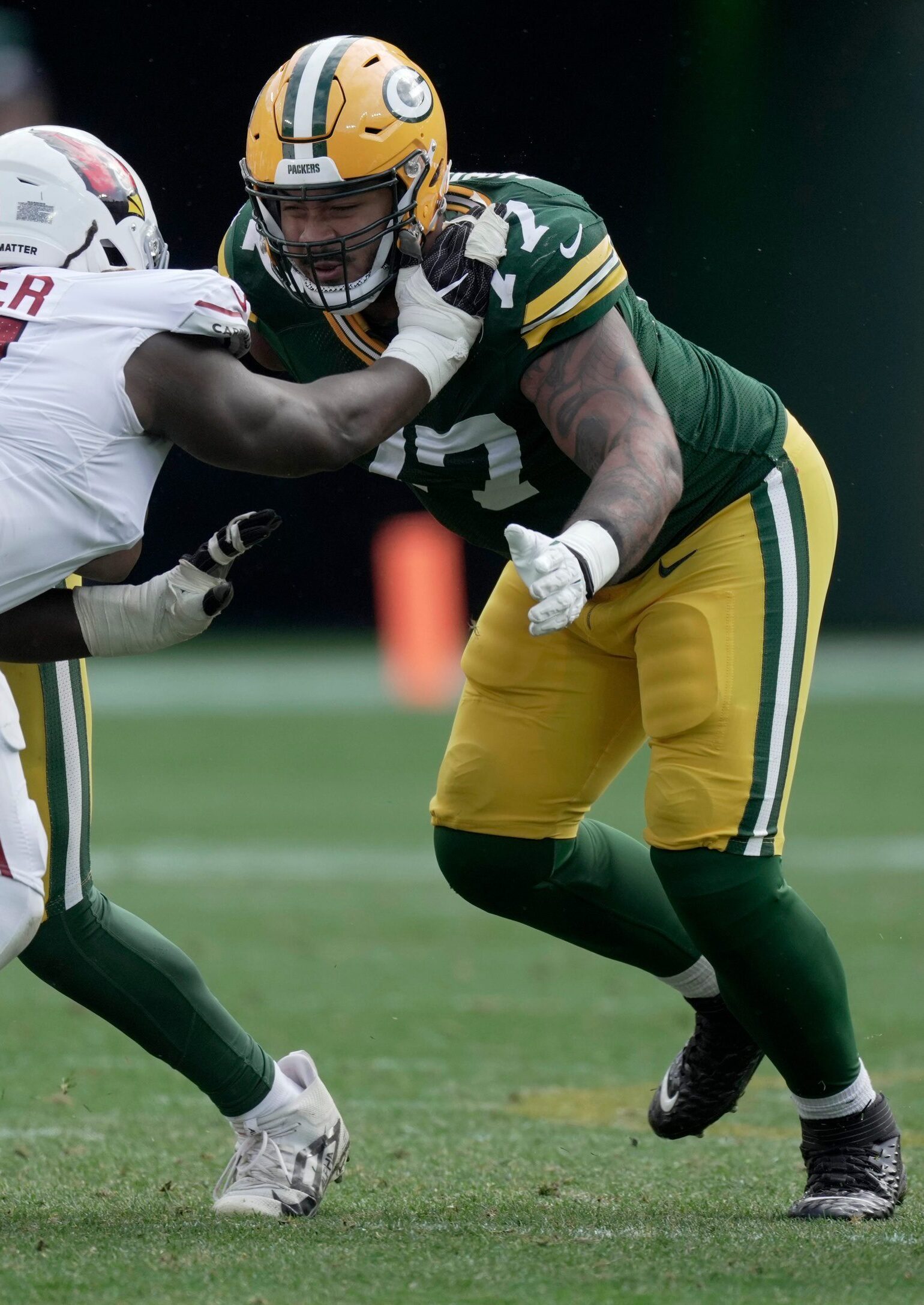 Green Bay Packers guard Zach Tom (50) and offensive tackle Jordan Morgan (77) team p to blocks Arizona Cardinals defensive end L.J. Collier (91) during the third quarter of their game Sunday, October 13, 2024 at Lambeau Field in Green Bay, Wisconsin. The Green Bay Packers beat the Arizona Cardinals 34-13.© Mark Hoffman/Milwaukee Journal Sentinel / USA TODAY NETWORK via Imagn Images
