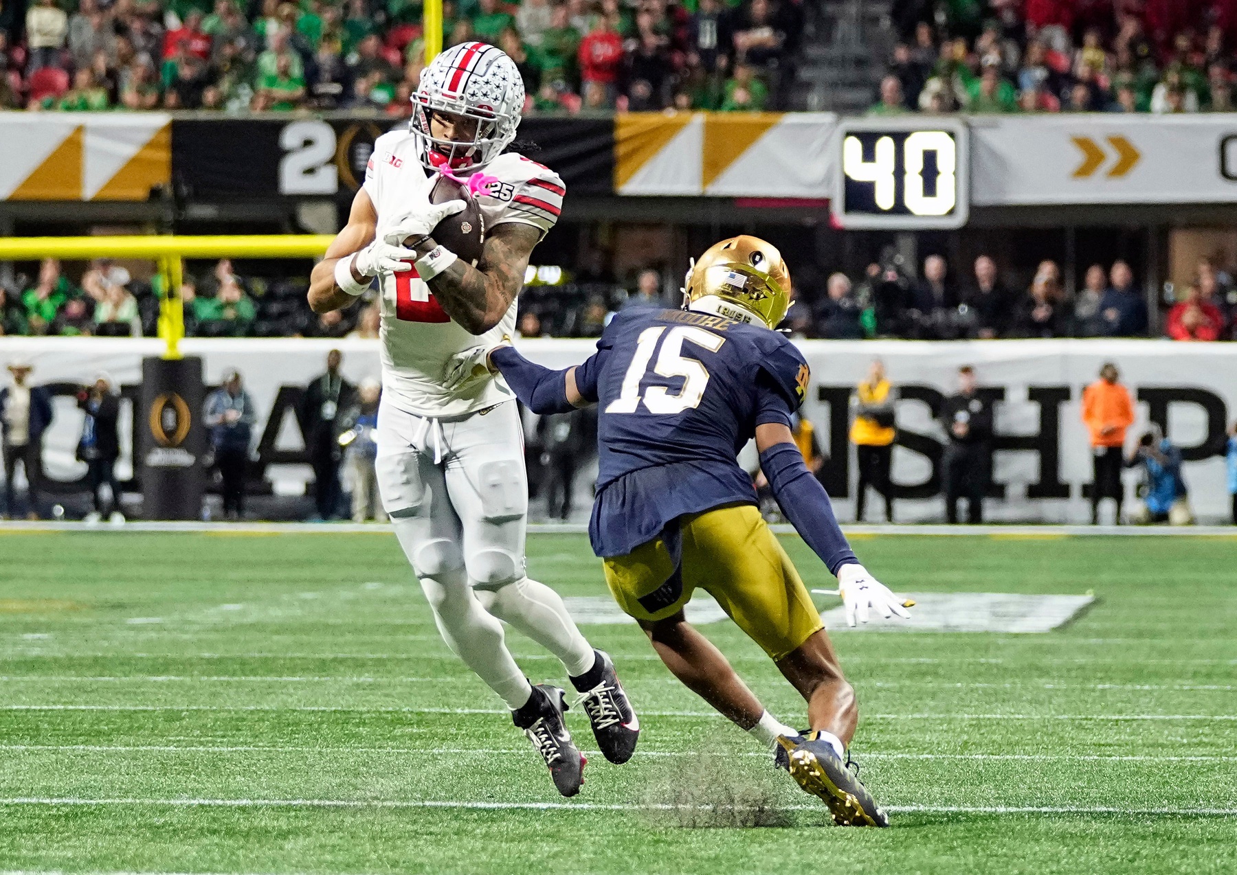 DENVER BRONCOS: Ohio State Buckeyes wide receiver Emeka Egbuka (2) makes a catch against Notre Dame Fighting Irish cornerback Leonard Moore (15) in the third quarter during the College Football Playoff championship at Mercedes-Benz Stadium in Atlanta on January 20, 2025. © Adam Cairns/Columbus Dispatch / USA TODAY NETWORK via Imagn Images Packers