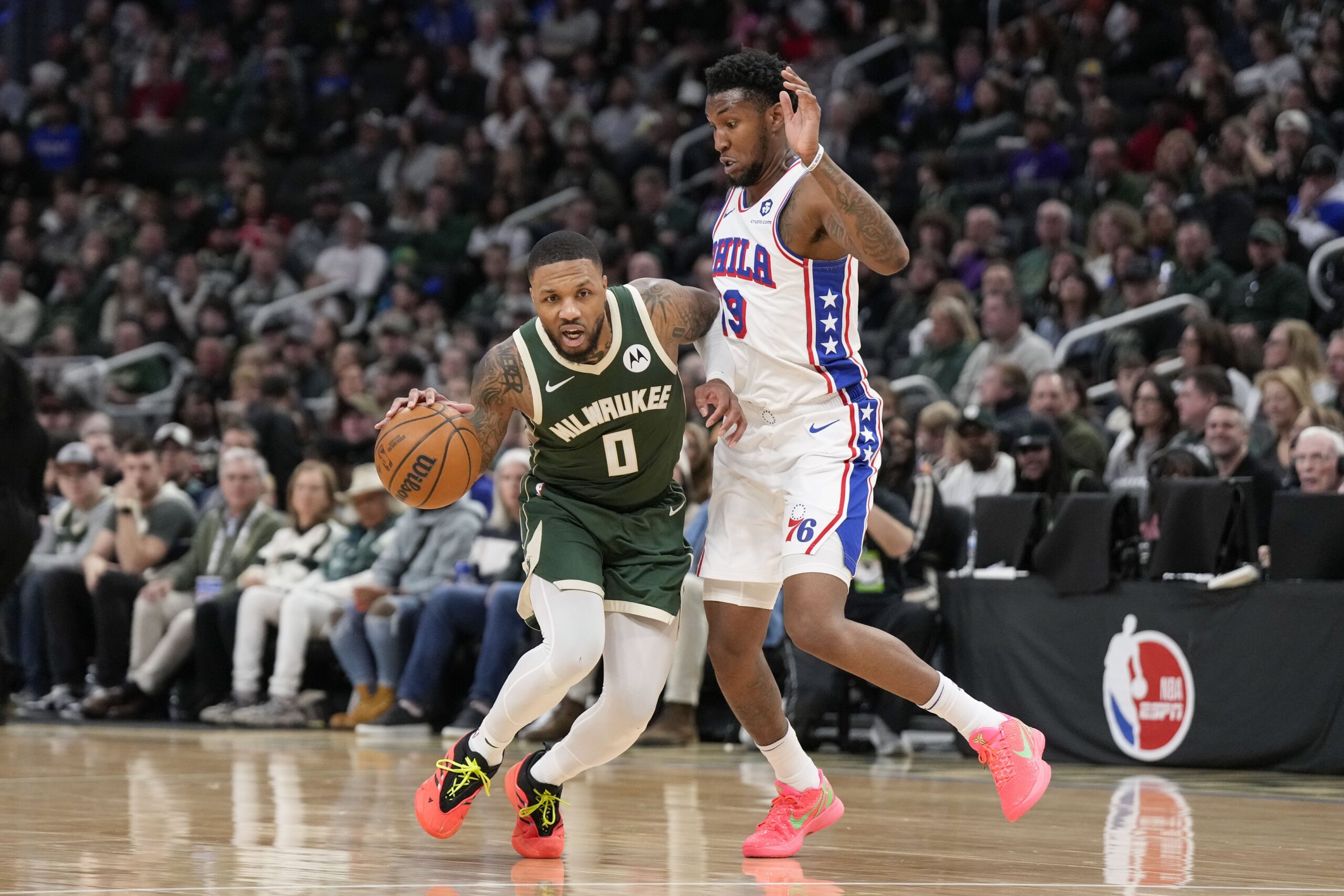 Feb 9, 2025; Milwaukee, Wisconsin, USA; Milwaukee Bucks guard Damian Lillard (0) drives for the basket against Philadelphia 76ers forward Justin Edwards (19) during the third quarter at Fiserv Forum. Mandatory Credit: Jeff Hanisch-Imagn Images