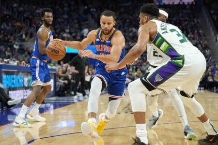 Mar 12, 2022; San Francisco, California, USA; Golden State Warriors guard Stephen Curry (30) dribbles against Milwaukee Bucks forward Giannis Antetokounmpo (34) during the third quarter at Chase Center. Mandatory Credit: Darren Yamashita-USA TODAY Sports