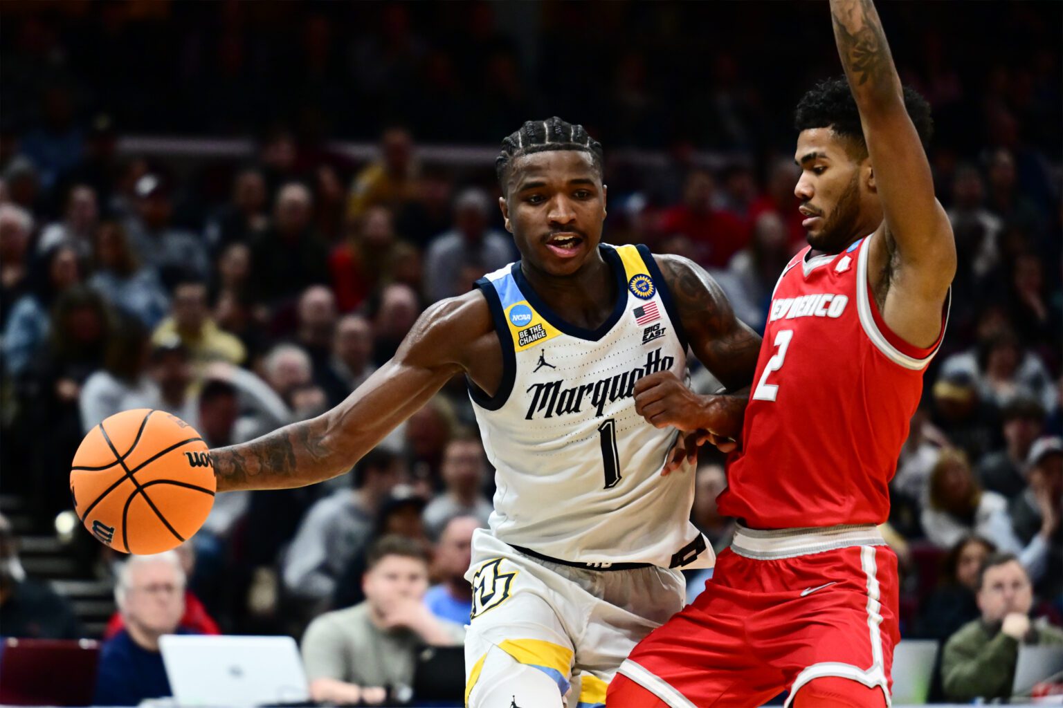 Kam Jones (1) plays the ball defended by New Mexico Lobos guard Donovan Dent (2)