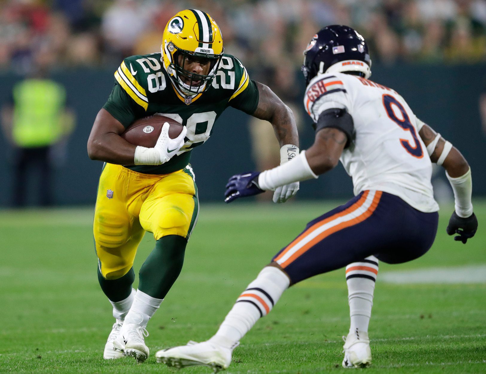 Green Bay Packers running back AJ Dillon (28) runs for a first down against Chicago Bears safety Jaquan Brisker (9) in the third quarter during their football game Sunday, September 18, 2022, at Lambeau Field in Green Bay, Wis. Dan Powers/USA TODAY NETWORK-Wisconsin
