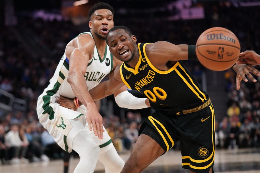 Mar 6, 2024; San Francisco, California, USA; Golden State Warriors forward Jonathan Kuminga (00) loses control of the ball next to Milwaukee Bucks forward Giannis Antetokounmpo (34) in the third quarter at the Chase Center. Mandatory Credit: Cary Edmondson-USA TODAY Sports