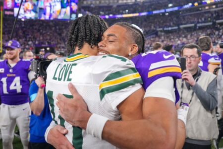 Minnesota Vikings wide receiver Justin Jefferson (18) hugs Green Bay Packers quarterback Jordan Love