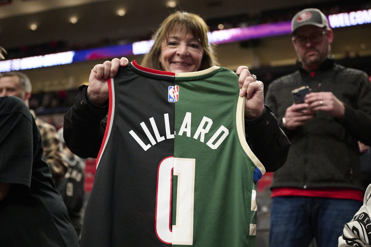 Bucks welcome Damian Lillard back with heartfelt message before Blazers game 1 Jan 31, 2024; Portland, Oregon, USA; A basketball fan holds a jersey with the colors and number of the Portland Trail Blazers and Milwaukee Bucks guard Damian Lillard (0) at Moda Center. Mandatory Credit: Troy Wayrynen-Imagn Images