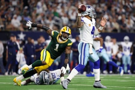 Dallas Cowboys quarterback Dak Prescott (4) throws under pressure from Green Bay Packers defensive end Micah Parsons (1).