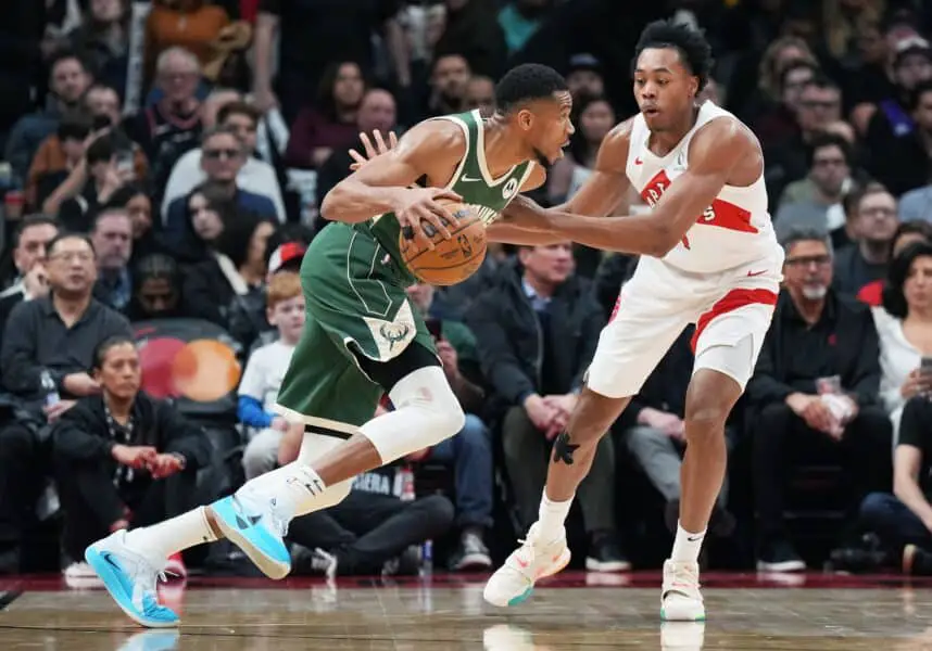 Jan 6, 2025; Toronto, Ontario, CAN; Milwaukee Bucks forward Giannis Antetokounmpo (34) controls the ball as Toronto Raptors forward Scottie Barnes (4) defends during the third quarter at Scotiabank Arena. Mandatory Credit: Nick Turchiaro-Imagn Images