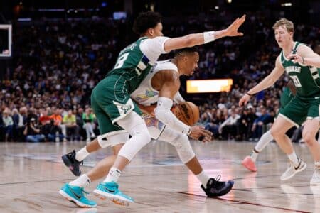 Mar 26, 2025; Denver, Colorado, USA; Denver Nuggets guard Russell Westbrook (4) controls the ball under pressure from Milwaukee Bucks guard Ryan Rollins (13) in the second quarter at Ball Arena. Mandatory Credit: Isaiah J. Downing-Imagn Images