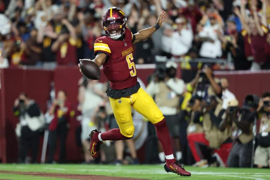 Aug 18, 2025; Landover, Maryland, USA; Washington Commanders quarterback Jayden Daniels (5) celebrates after scoring a touchdown against Cincinnati Bengals during the first half at Northwest Stadium. Mandatory Credit: Amber Searls-Imagn Images