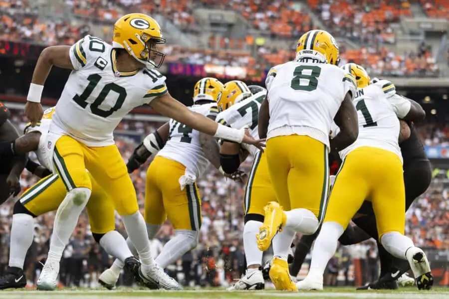 Sep 21, 2025; Cleveland, Ohio, USA; Green Bay Packers quarterback Jordan Love (10) drops back to the end zone to hand the ball off to running back Josh Jacobs (8) against the Cleveland Browns during the fourth quarter at Huntington Bank Field. Mandatory Credit: Scott Galvin-Imagn Images
