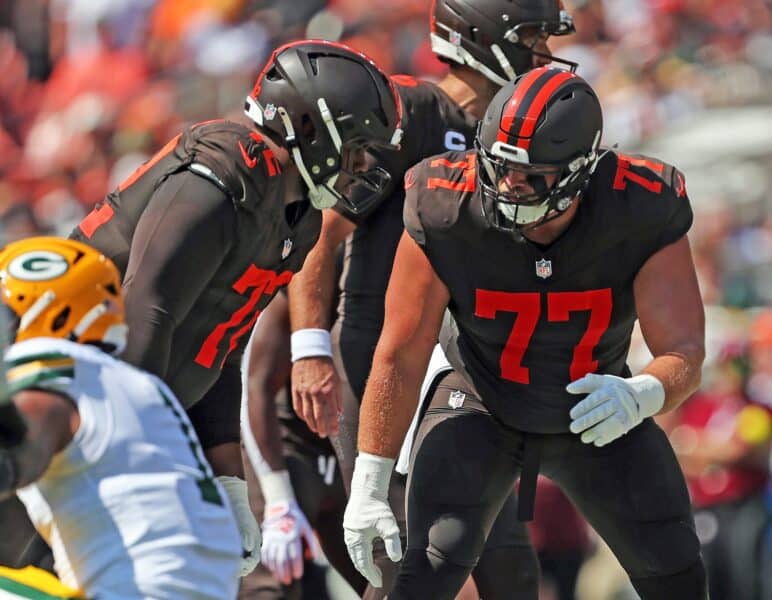 Cleveland Browns guard Wyatt Teller (77) has a word with offensive tackle KT Leveston (72) before a play during the first half of an NFL football game at Huntington Bank Field, Sept. 21, 2025, in Cleveland, Ohio.