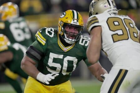 Green Bay Packers guard Zach Tom (50) blocks New Orleans Saints defensive end Payton Turner (98) during the third quarter of their game Monday, December 23, 2024 at Lambeau Field in Green Bay, Wisconsin.