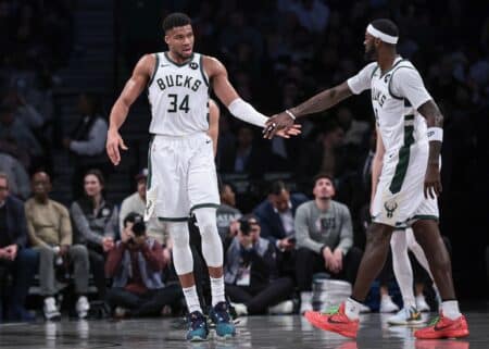 Dec 27, 2023; Brooklyn, New York, USA; Milwaukee Bucks forward Giannis Antetokounmpo (34) slaps hands with forward Bobby Portis (9) during the first half against the Brooklyn Nets at Barclays Center. Mandatory Credit: Vincent Carchietta-Imagn Images