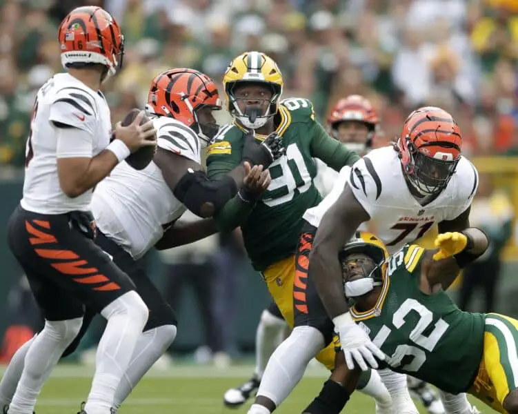 Packers defense looks elite early, but late-game lapses remain a concern 2 Oct 12, 2025; Green Bay, Wisconsin, USA; Green Bay Packers defensive tackle Warren Brinson (91) rushes Cincinnati Bengals quarterback Joe Flacco (16) during the game at Lambeau Field. Mandatory Credit: William Glasheen-USA TODAY Network via Imagn Images