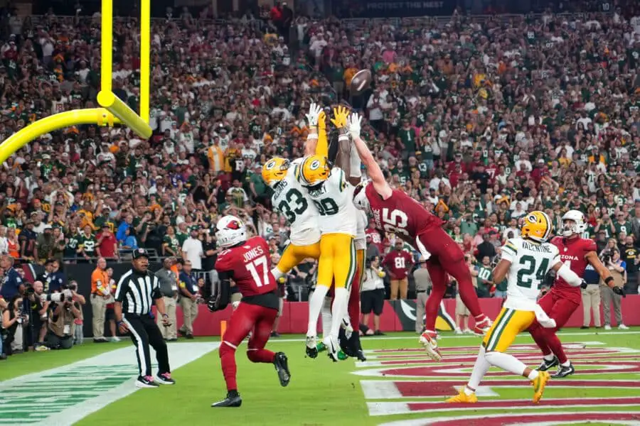 Oct 19, 2025; Glendale, Arizona, USA; Arizona Cardinals and Green Bay Packers players go for a jump ball on the final play of the game during the second half at State Farm Stadium. Mandatory Credit: Joe Camporeale-Imagn Images