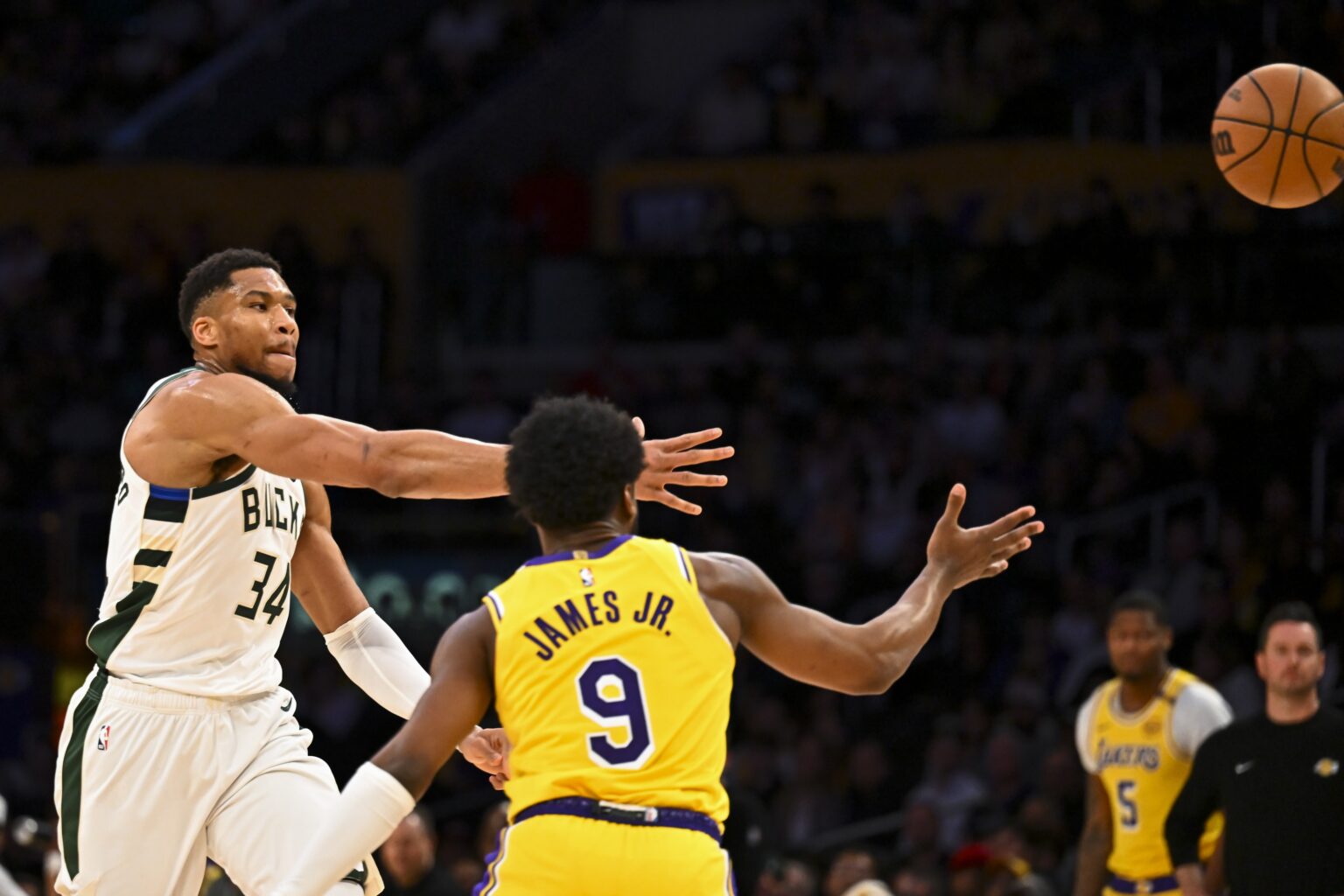 Mar 20, 2025; Los Angeles, California, USA; Milwaukee Bucks forward Giannis Antetokounmpo (34) passes against Los Angeles Lakers guard Bronny James (9) during the first half at Crypto.com Arena. Mandatory Credit: Jonathan Hui-Imagn Images