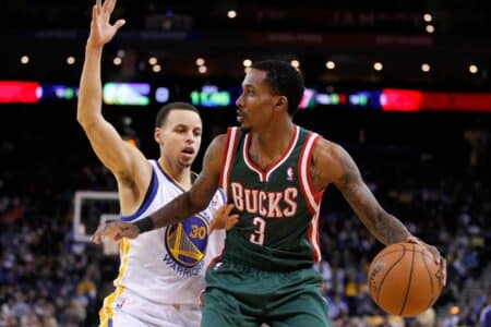 Mar 9, 2013; Oakland, CA, USA; Milwaukee Bucks guard Brandon Jennings (3) dribbles the ball next to Golden State Warriors guard Stephen Curry (30) in the first quarter at ORACLE arena. Mandatory Credit: Cary Edmondson-Imagn Images