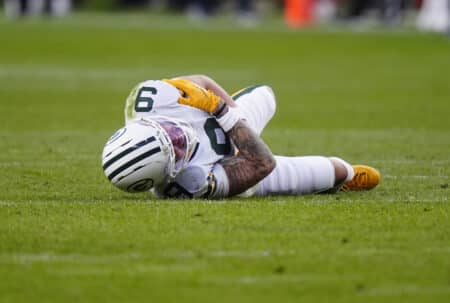 Dec 14, 2025; Denver, Colorado, USA; Green Bay Packers wide receiver Christian Watson (9) lies on the field following an injury during the third quarter against the Denver Broncos at Empower Field at Mile High. Mandatory Credit: Ron Chenoy-Imagn Images