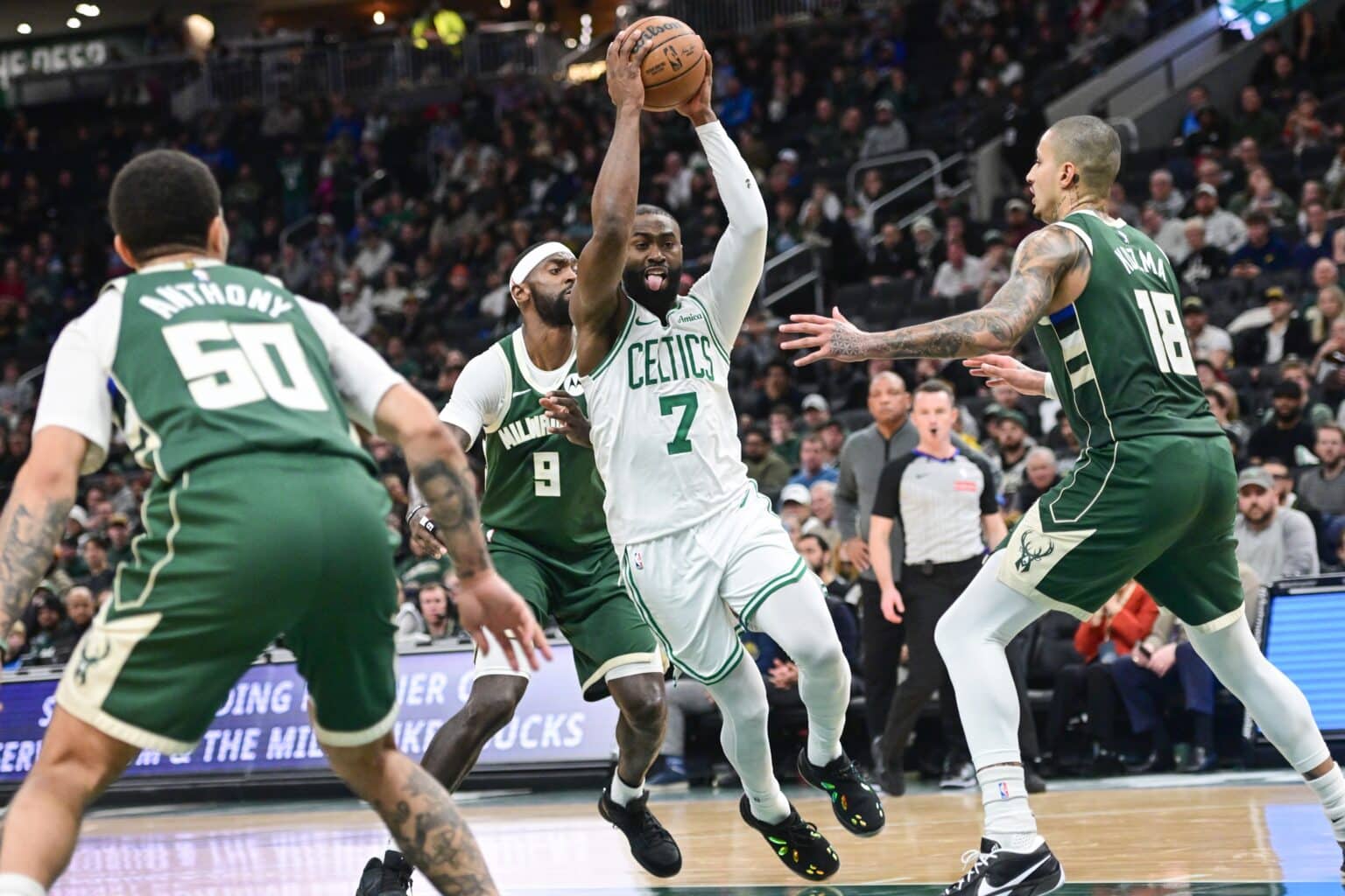 Bucks make NBA history in win over Celtics Dec 11, 2025; Milwaukee, Wisconsin, USA; Boston Celtics forward Jaylen Brown (7) drives to the basket between Milwaukee Bucks forward Bobby Portis (9) and forward Kyle Kuzma (18) in the fourth quarter at Fiserv Forum. Mandatory Credit: Benny Sieu-Imagn Images